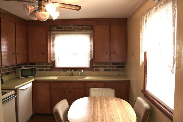 311 N Rogers Pkwy W, Irondequoit, NY 14617 - kitchen with white appliances, a sink, light countertops, backsplash, and ceiling fan