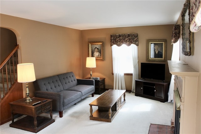 311 N Rogers Pkwy W, Irondequoit, NY 14617 - living room featuring light carpet, stairway, a fireplace, and arched walkways