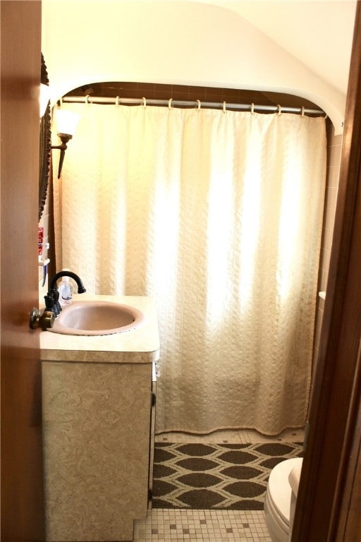 311 N Rogers Pkwy W, Irondequoit, NY 14617 - bathroom featuring vanity, toilet, a shower with shower curtain, and tile patterned flooring