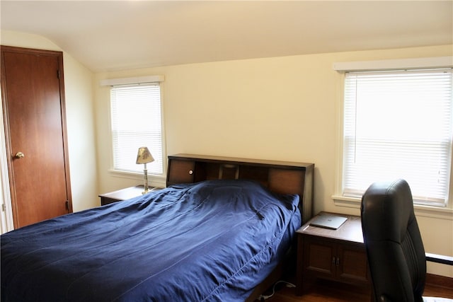 311 N Rogers Pkwy W, Irondequoit, NY 14617 - bedroom with vaulted ceiling, multiple windows, baseboards, and dark wood-style floors