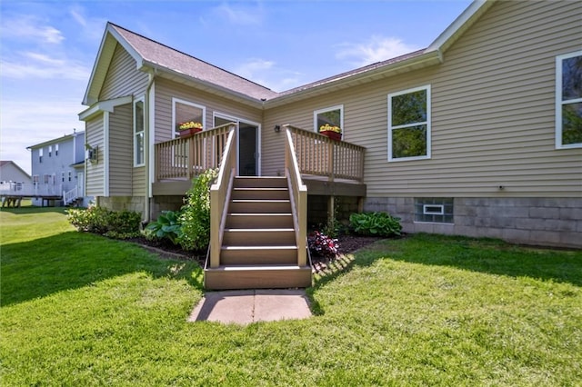 1401 Mountain Laurel Ln, Ontario, NY 14519 - rear view of property with a wooden deck and a lawn