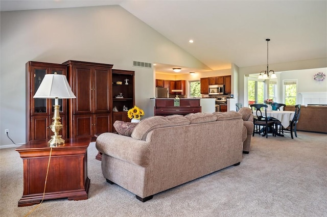 1401 Mountain Laurel Ln, Ontario, NY 14519 - living room featuring light colored carpet, high vaulted ceiling, a chandelier, and recessed lighting