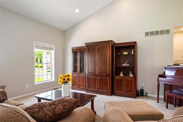 1401 Mountain Laurel Ln, Ontario, NY 14519 - living room with high vaulted ceiling, light colored carpet, baseboards, and recessed lighting