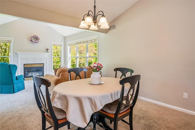 1401 Mountain Laurel Ln, Ontario, NY 14519 - dining space with vaulted ceiling, carpet, plenty of natural light, baseboards, and a fireplace