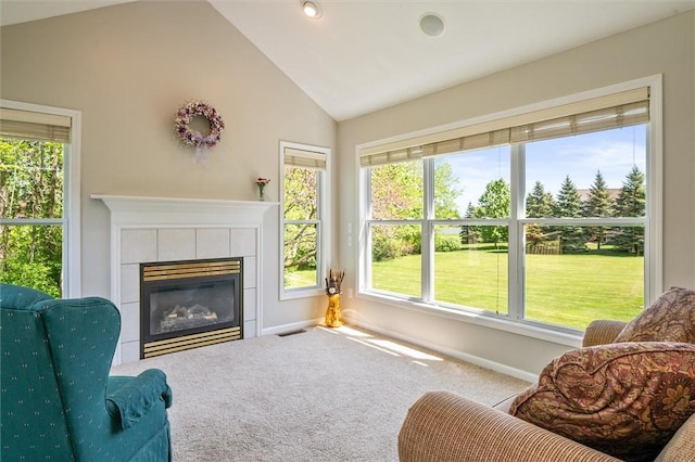 1401 Mountain Laurel Ln, Ontario, NY 14519 - living area with a tile fireplace, carpet, baseboards, and high vaulted ceiling