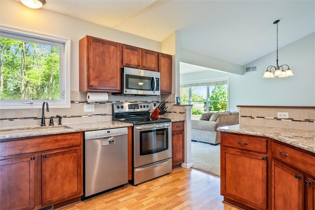 1401 Mountain Laurel Ln, Ontario, NY 14519 - kitchen featuring appliances with stainless steel finishes, a sink, tasteful backsplash, light wood finished floors, and vaulted ceiling