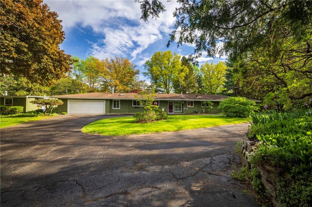 4282 E Ave, Pittsford, NY 14618 - ranch-style home with asphalt driveway, a garage, and a front lawn