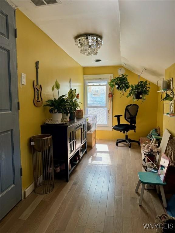 512 Sherman St, Buffalo, NY 14211 - entrance foyer with hardwood / wood-style floors, vaulted ceiling, baseboards, and a chandelier