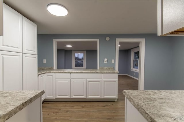 118 Leray St, Le Ray, NY 13612 - kitchen featuring light countertops, white cabinets, and light wood finished floors