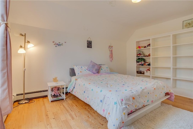 54 Beaver St, Otsego, NY 13326 - bedroom featuring a baseboard heating unit, wood finished floors, and vaulted ceiling