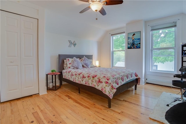 54 Beaver St, Otsego, NY 13326 - bedroom featuring a baseboard heating unit, light wood-style floors, multiple windows, and lofted ceiling