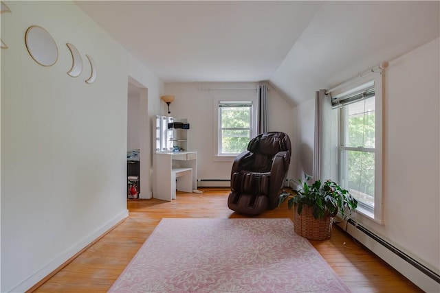 54 Beaver St, Otsego, NY 13326 - living area featuring a baseboard heating unit, lofted ceiling, wood finished floors, and baseboards