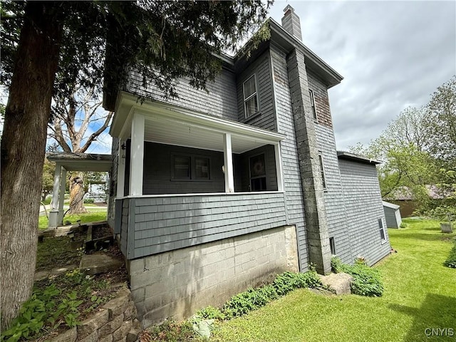 26 Farnham St, Cazenovia, NY 13035 - view of side of home with a chimney, a yard, and covered porch