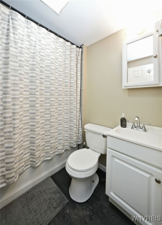 3564 Grafton Ave, Hamburg, NY 14219 - full bath with vanity, toilet, shower / tub combo with curtain, wood finished floors, and baseboards