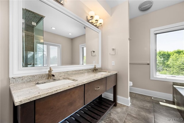 13 Ojibwa Cir, Buffalo, NY 14202 - bathroom featuring double vanity, toilet, baseboards, and tile patterned flooring
