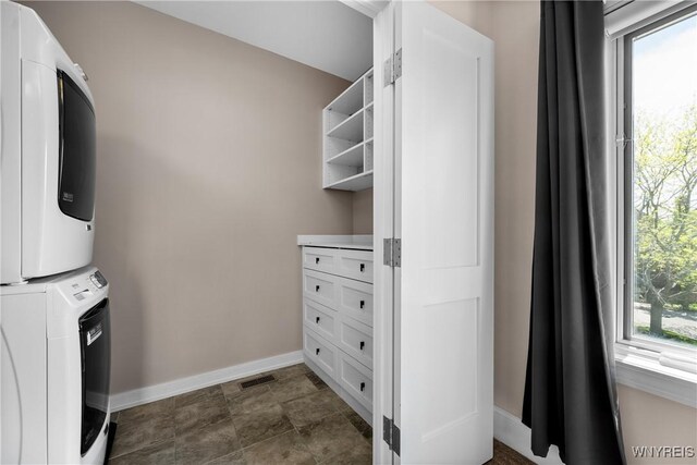 13 Ojibwa Cir, Buffalo, NY 14202 - laundry room featuring stacked washing machine and dryer and baseboards