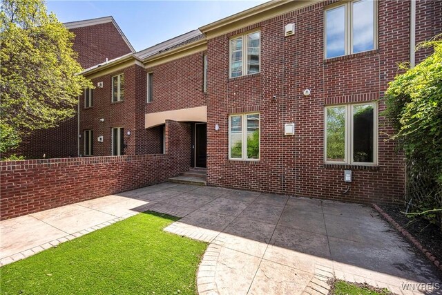 13 Ojibwa Cir, Buffalo, NY 14202 - back of property with a patio area and brick siding