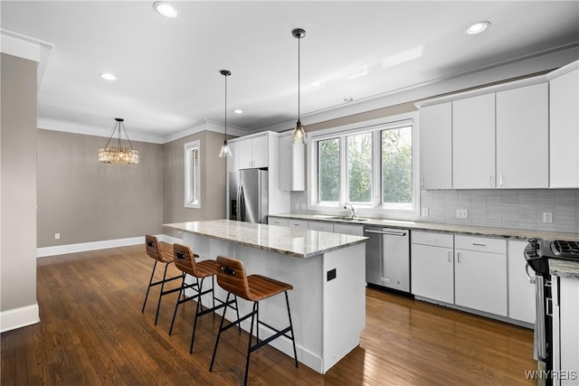 13 Ojibwa Cir, Buffalo, NY 14202 - kitchen with appliances with stainless steel finishes, baseboards, a sink, a center island, and tasteful backsplash