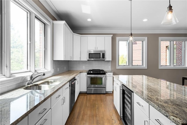 13 Ojibwa Cir, Buffalo, NY 14202 - kitchen featuring stainless steel appliances, beverage cooler, a sink, white cabinets, and recessed lighting