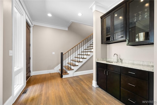 13 Ojibwa Cir, Buffalo, NY 14202 - indoor wet bar with baseboards, ornamental molding, light wood-type flooring, stairway, and recessed lighting