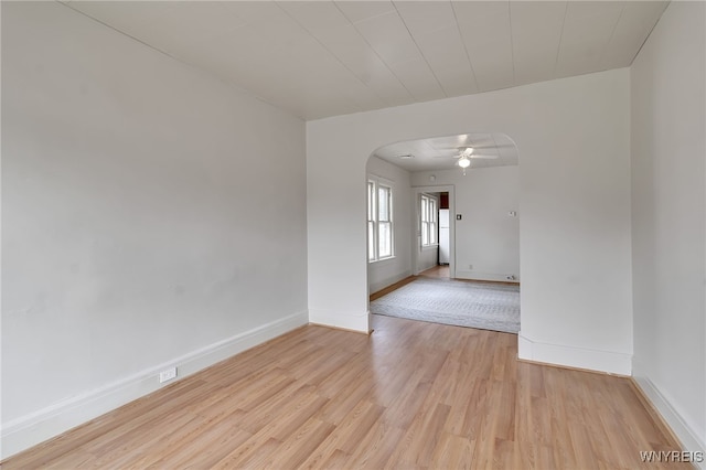 151 Edson St, West Seneca, NY 14210 - empty room with arched walkways, light wood-style floors, baseboards, and ceiling fan