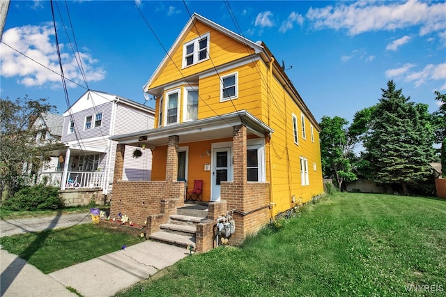 151 Edson St, West Seneca, NY 14210 - view of front of property featuring covered porch, a front yard, and brick siding