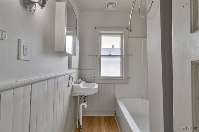 151 Edson St, West Seneca, NY 14210 - full bath featuring wainscoting, a bath, wood finished floors, a sink, and a shower