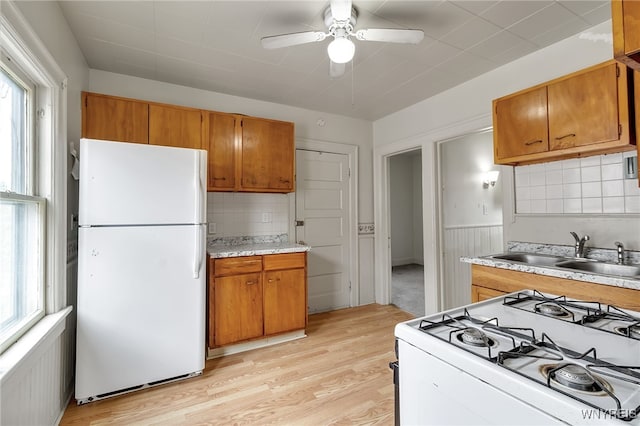 151 Edson St, West Seneca, NY 14210 - kitchen with white appliances, a sink, ceiling fan, brown cabinetry, and light countertops