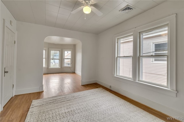 151 Edson St, West Seneca, NY 14210 - spare room featuring arched walkways, light wood-type flooring, baseboards, and ceiling fan