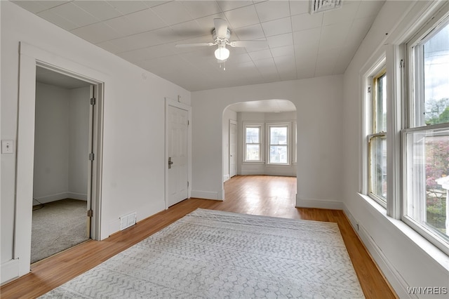 151 Edson St, West Seneca, NY 14210 - unfurnished room with arched walkways, wood finished floors, a ceiling fan, and baseboards