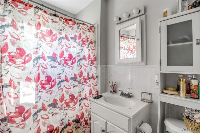 151 Edson St, West Seneca, NY 14210 - bathroom with tile walls, vanity, a shower with curtain, a wainscoted wall, and toilet