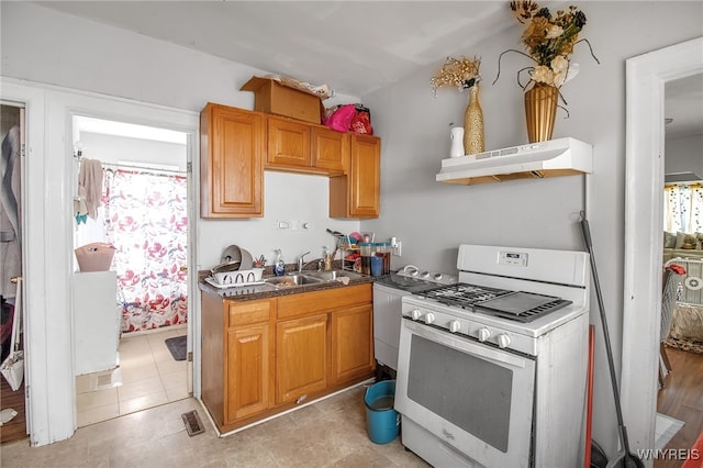 151 Edson St, West Seneca, NY 14210 - kitchen with gas range gas stove, under cabinet range hood, a sink, dark countertops, and open shelves