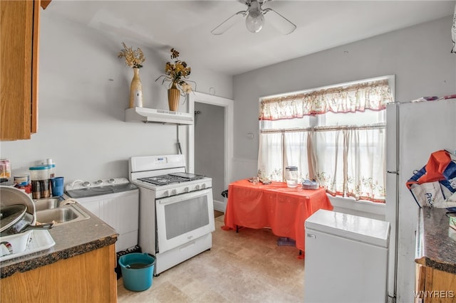 151 Edson St, West Seneca, NY 14210 - kitchen featuring white appliances, washer / dryer, under cabinet range hood, ceiling fan, and dark countertops