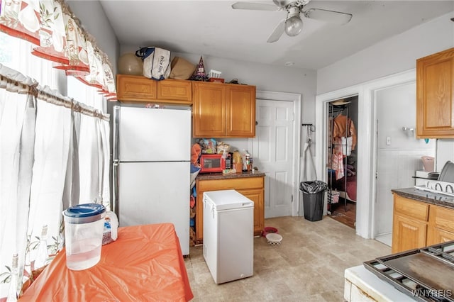 151 Edson St, West Seneca, NY 14210 - kitchen with freestanding refrigerator, fridge, ceiling fan, and dark countertops