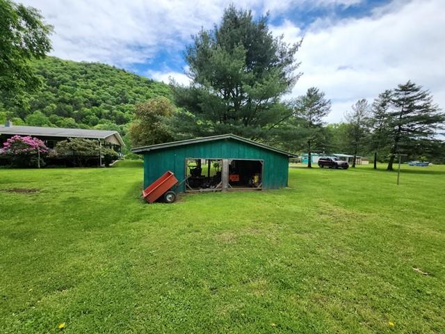 3483 First Fork Rd, Grove Twp, PA 15861 - view of green lawn featuring an outbuilding and a garage