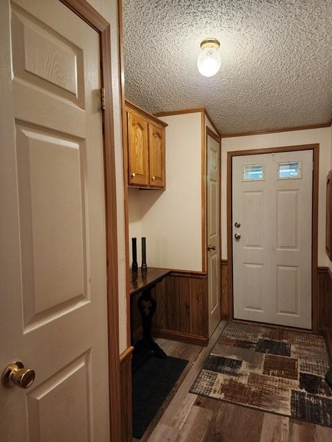 3483 First Fork Rd, Grove Twp, PA 15861 - entrance foyer featuring dark wood finished floors, a wainscoted wall, and a textured ceiling