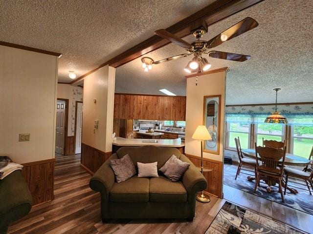 3483 First Fork Rd, Grove Twp, PA 15861 - living area with wooden walls, a textured ceiling, a wainscoted wall, wood finished floors, and a ceiling fan