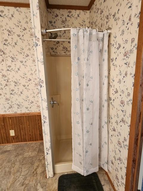 3483 First Fork Rd, Grove Twp, PA 15861 - full bath with wallpapered walls, a stall shower, wainscoting, crown molding, and wooden walls