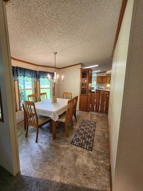 3483 First Fork Rd, Grove Twp, PA 15861 - dining space featuring a textured ceiling, a chandelier, and crown molding