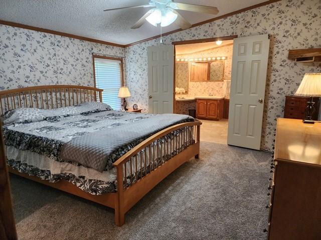 3483 First Fork Rd, Grove Twp, PA 15861 - bedroom featuring wallpapered walls, crown molding, carpet flooring, ensuite bath, and a ceiling fan