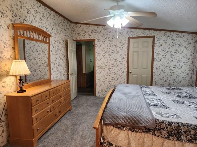 3483 First Fork Rd, Grove Twp, PA 15861 - carpeted bedroom featuring ornamental molding, wallpapered walls, a textured ceiling, and a ceiling fan
