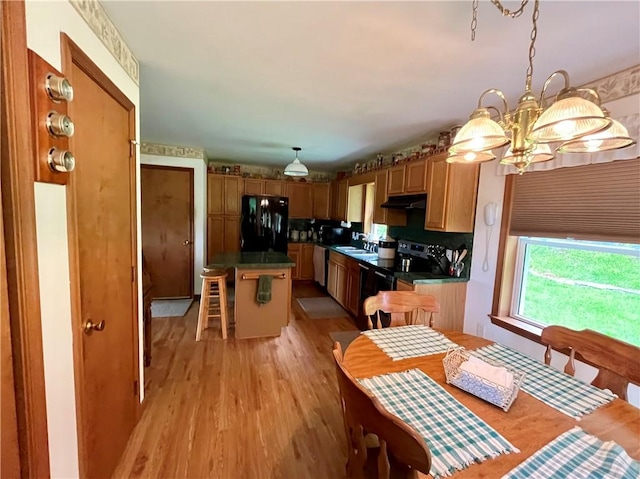 8255 County Highway 2, Andes, NY 13731 - kitchen with black appliances, a sink, dark countertops, and a center island