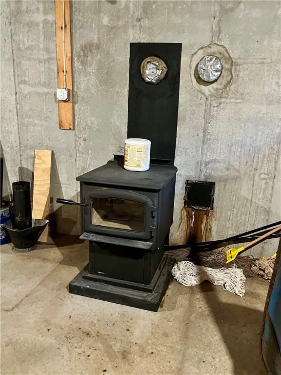 8255 County Highway 2, Andes, NY 13731 - detailed view of unfinished concrete flooring and a wood stove