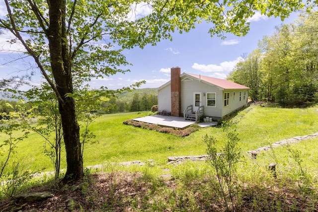 8255 County Highway 2, Andes, NY 13731 - back of house with a chimney, a patio, entry steps, and a yard