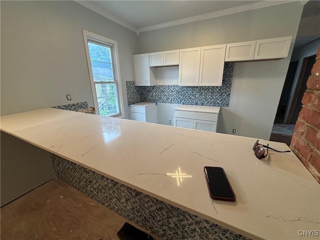 102 Milton Ave, Syracuse, NY 13204 - kitchen featuring light stone counters, white cabinets, crown molding, and backsplash