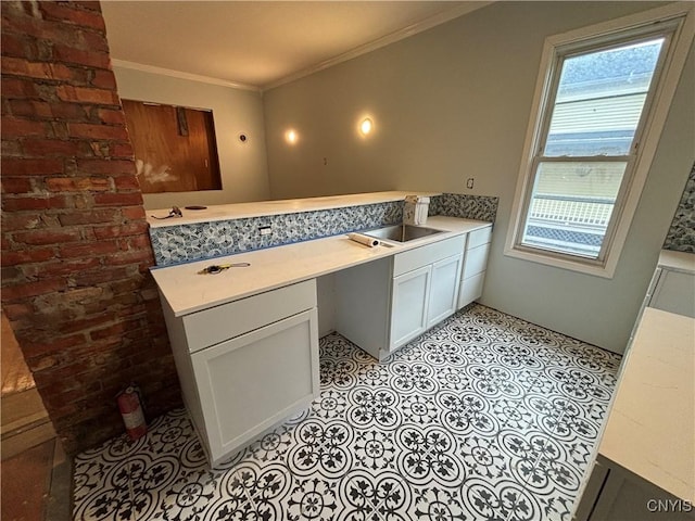 102 Milton Ave, Syracuse, NY 13204 - kitchen with ornamental molding, light countertops, a peninsula, and white cabinets