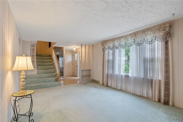 112 Vanida Dr, Camillus, NY 13031 - unfurnished living room with carpet and stairway