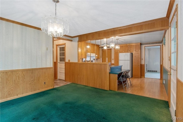 112 Vanida Dr, Camillus, NY 13031 - kitchen with a chandelier, freestanding refrigerator, wainscoting, ornamental molding, and light colored carpet