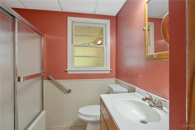 112 Vanida Dr, Camillus, NY 13031 - bathroom featuring wainscoting, toilet, vanity, and combined bath / shower with glass door