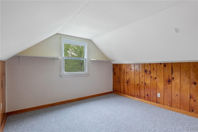 112 Vanida Dr, Camillus, NY 13031 - additional living space featuring carpet, baseboards, vaulted ceiling, and wood walls